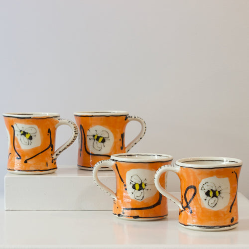 PH: Orange bee mugs